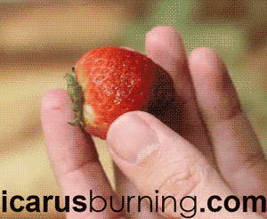 GIF showing how to remove a strawberry stem with a straw